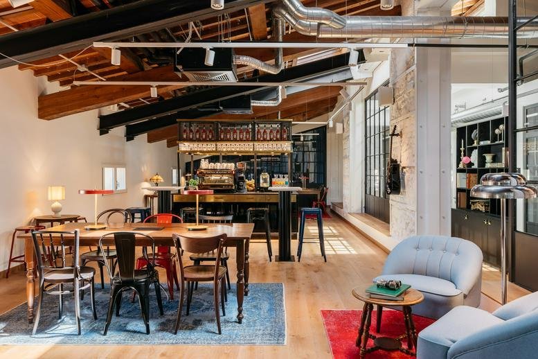 Spacious communal lounge at Piazza Della Libertà 14 featuring rustic beams, a bar, and eclectic seating.