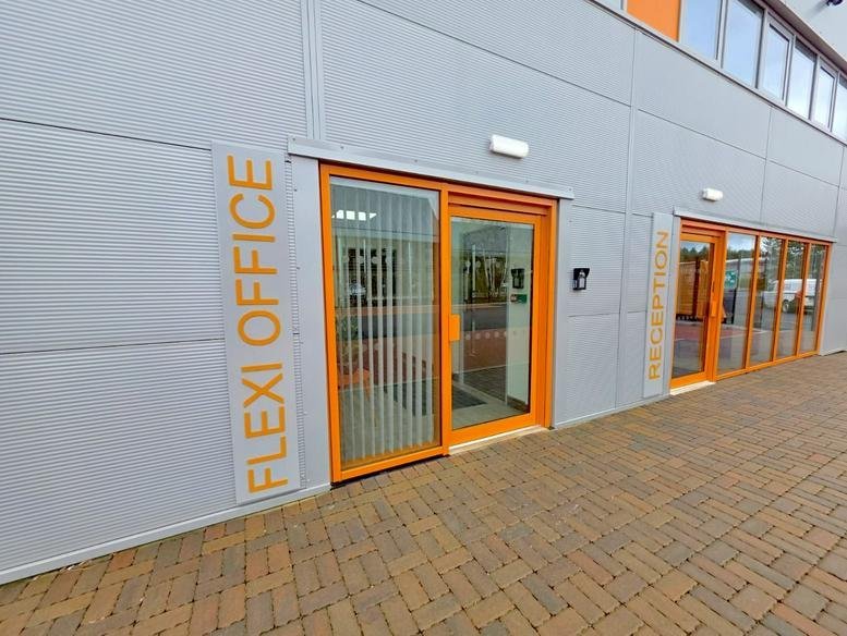 Exterior view of Ratio Park, Fine Point Way featuring bright orange window frames and accessible entrance.