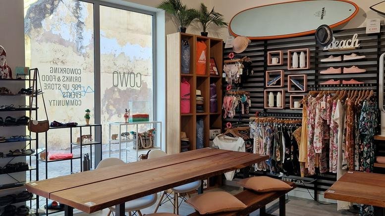 Spacious coworking area at Rua Francisco Pablo, 4c with wooden communal tables and beach-themed decor.