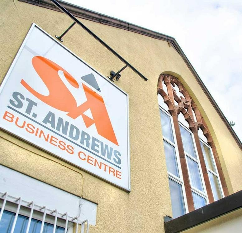Exterior facade of Saint Andrews Business Centre featuring traditional arched windows and prominent signage.