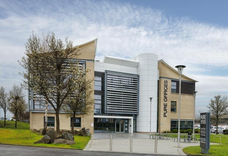 Exterior view of the modern stone and glass facade of 1 Ainslie Road, Hillington Park, Glasgow.