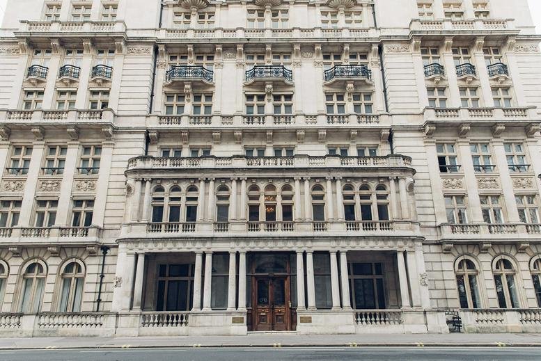 The grand historic stone facade of 1 Horse Guards Avenue featuring classical columns and balconies.