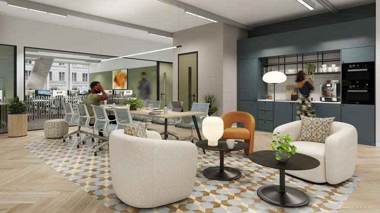 Spacious communal lounge and kitchen area with colorful armchairs and a decorative patterned rug.