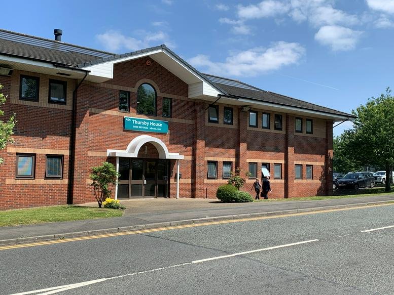 Exterior view of the brick facade and entrance of Thursby House at 1 Thursby Road.