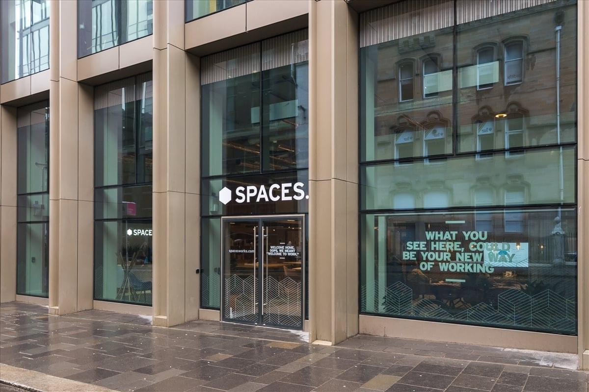 Exterior entrance of 1 West Regent Street featuring modern glass facade and Spaces branding.