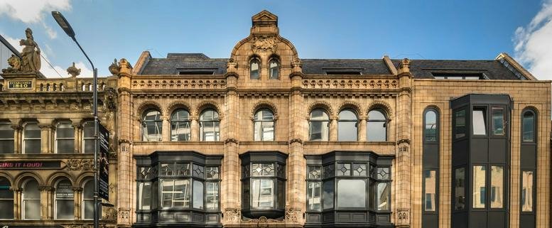 Exterior view of the ornate stone facade of 10-12 East Parade, Leeds.