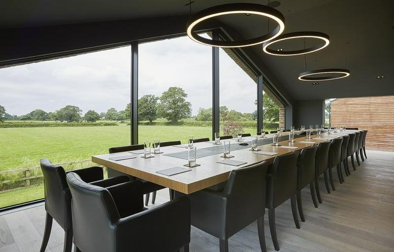 Spacious boardroom at 10 West Street, Alderley Edge, Cheshire with a long wooden table and panoramic views.
