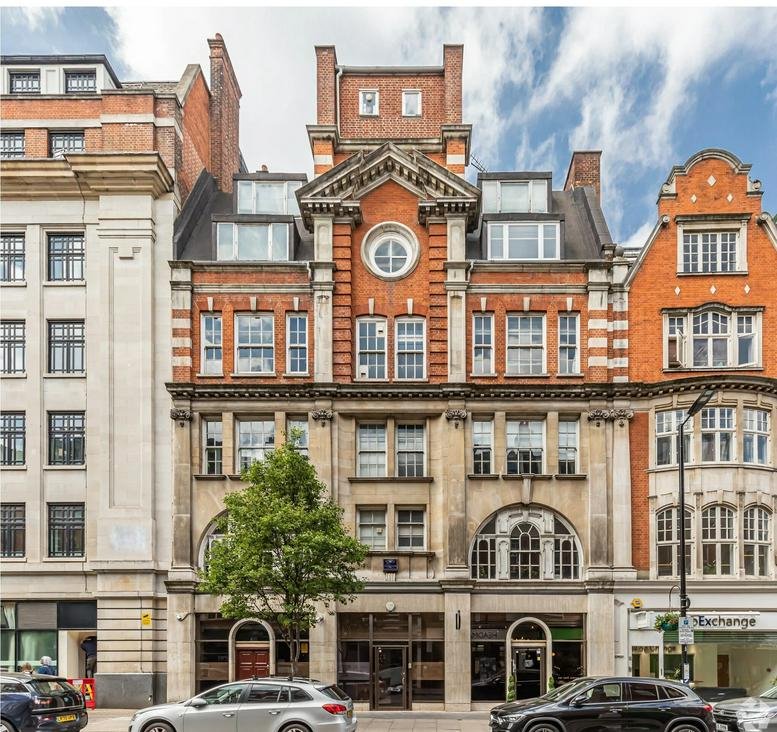 Exterior facade of 101 Great Portland Street, London, featuring red brick and classical stone architectural details.