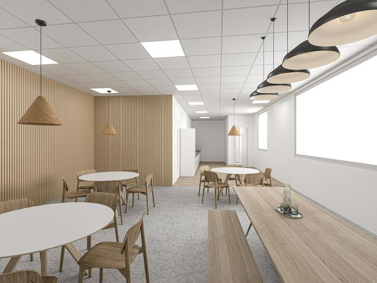 Spacious communal dining area at 101 Victoria Street with wooden tables and modern pendant lighting.