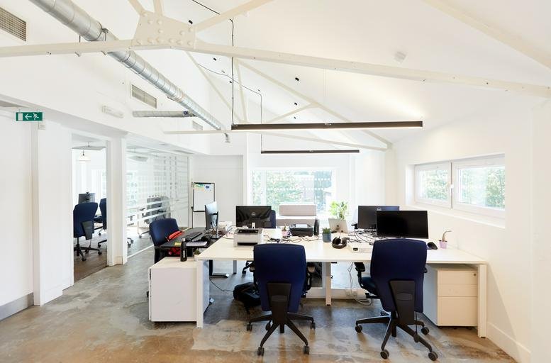 Spacious open-plan workspace at 102 St Pancras Way with vaulted ceilings and exposed white beams.
