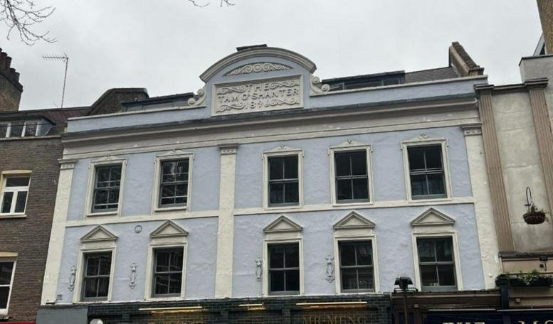Exterior view of the light blue classical facade of 103, Charing Cross Road, London.