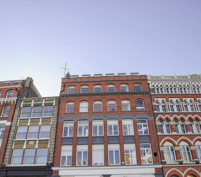 Exterior view of the red brick and stone facade of Farringdon House, 105-107 Farringdon Road.