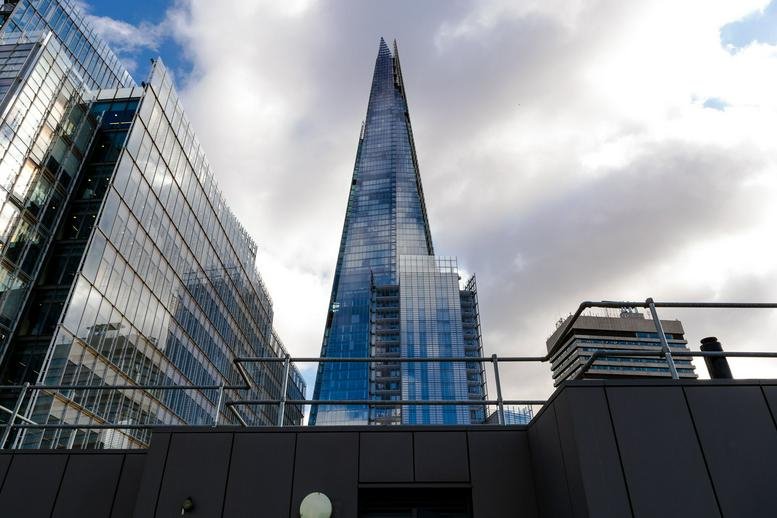 Exterior view of the modern glass facade at 11-15 Borough High Street with The Shard in the background.