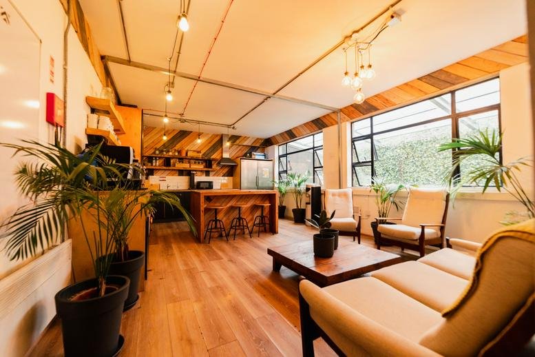 Spacious communal lounge and kitchen area at 11-15 Tara Street featuring wooden floors and natural light.