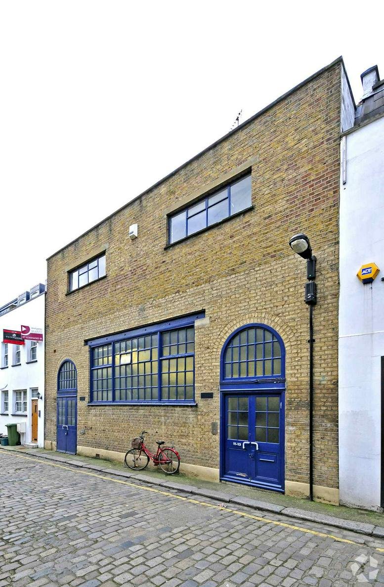 Brick exterior facade of 11, King’s Terrace, London with large blue windows and a matching arched door.