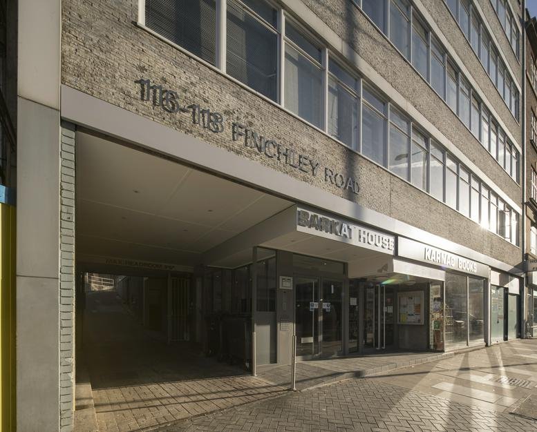 Exterior facade and street entrance of the Barkat House building at 116-118 Finchley Road.