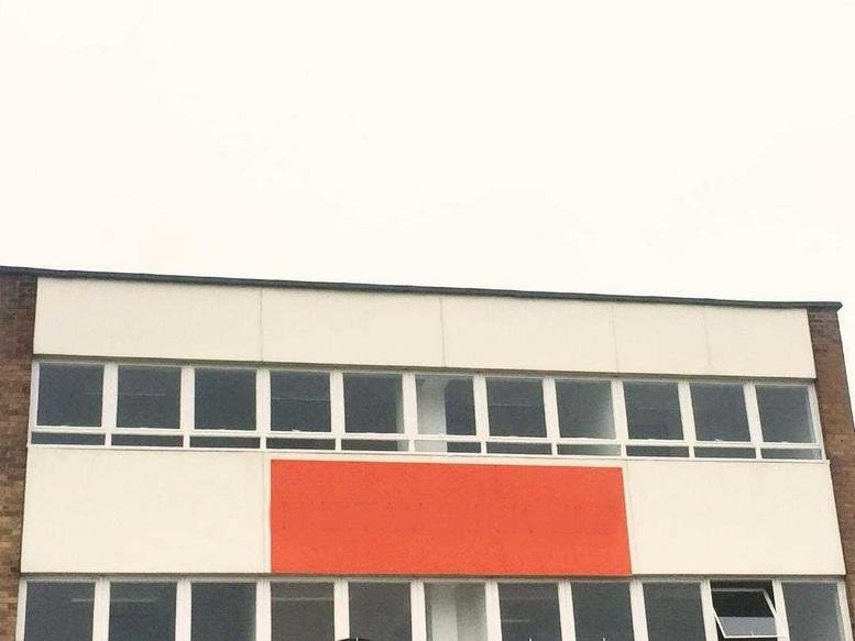 Exterior facade of 117 Hook Road featuring white panels and a bright orange accent section.