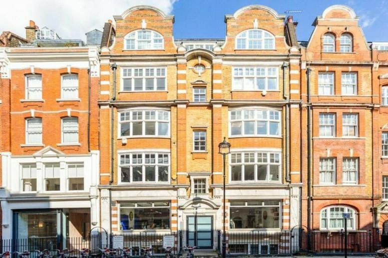 Exterior view of the historic red brick building at 118-120 Great Titchfield Street.