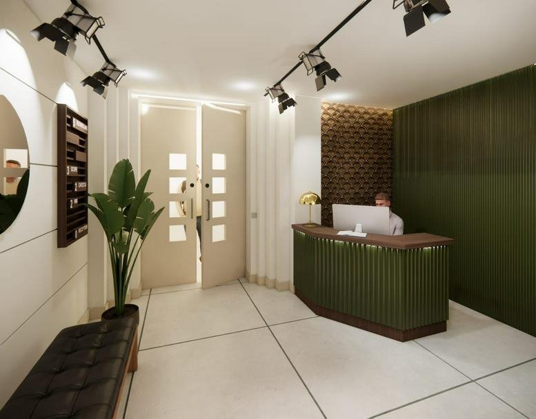 Reception area at 119 Wardour Street featuring a dark green desk, wood-slat wall, and indoor plant.
