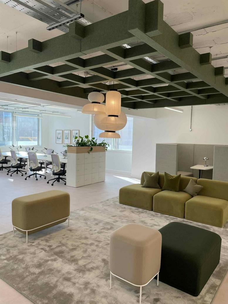 Lounge area with olive green seating and an ornate wooden ceiling grid at 12, Cock Lane, City of London.