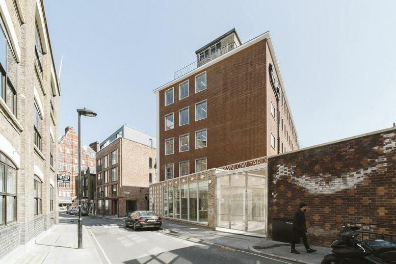 Exterior view of the brick facade and modern entrance at 12 Roger Street, London.