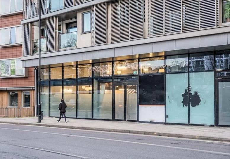 Exterior facade and street entrance of 122 East Road, Unit 2, The Yard, featuring large glass windows.