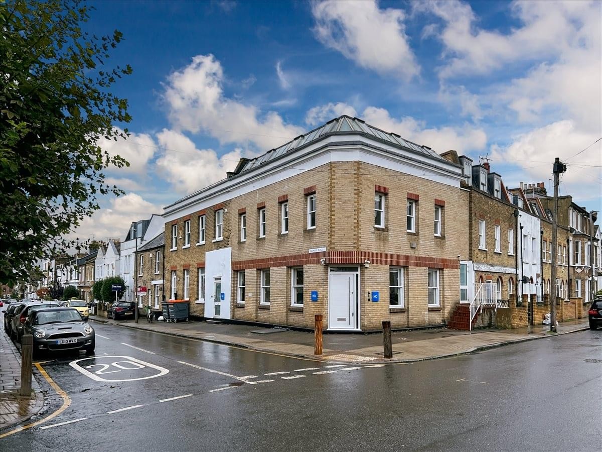 Corner exterior view of the brick building at 123 Disraeli Road and 1a Edith Villas.