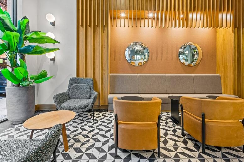 Spacious reception area with plush armchairs and geometric floor tiles at 124 St Vincent Street, Framework.