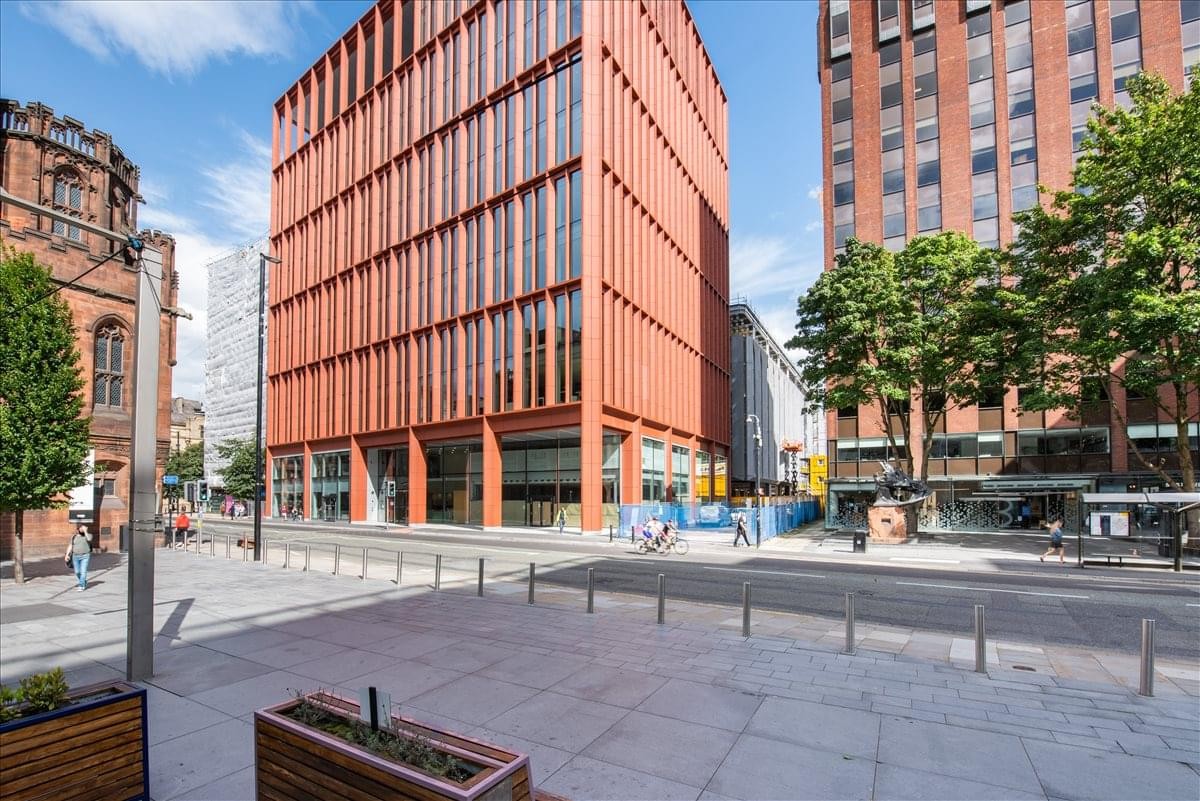 Modern red-toned exterior facade of 125 Deansgate, Greater Manchester.