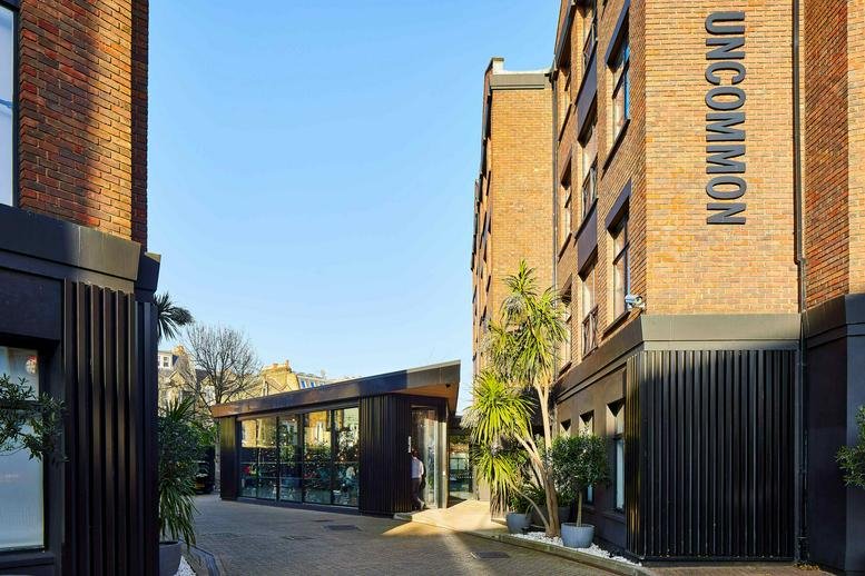 Exterior view of the brick facade at 126 New King's Road, Fulham with prominent signage.