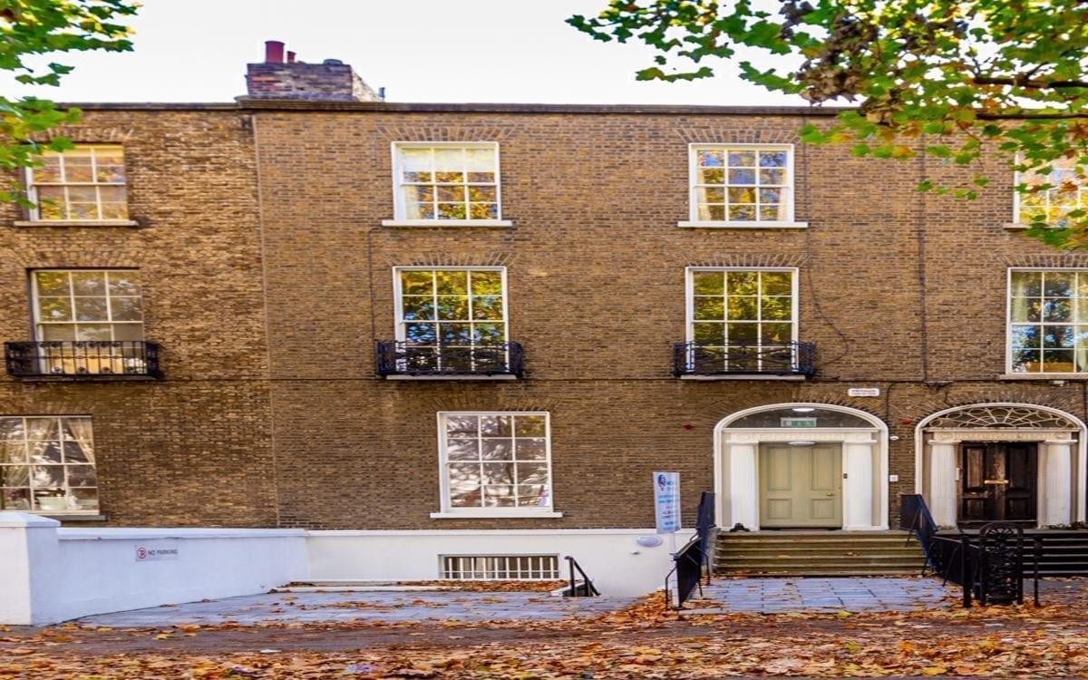 Exterior brick facade of 13 Adelaide Road showing the traditional entrance and windows.
