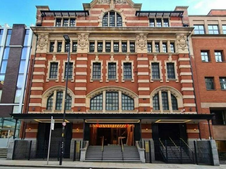 Grand red brick facade and ornate entrance of 13 Quay Street, Manchester.