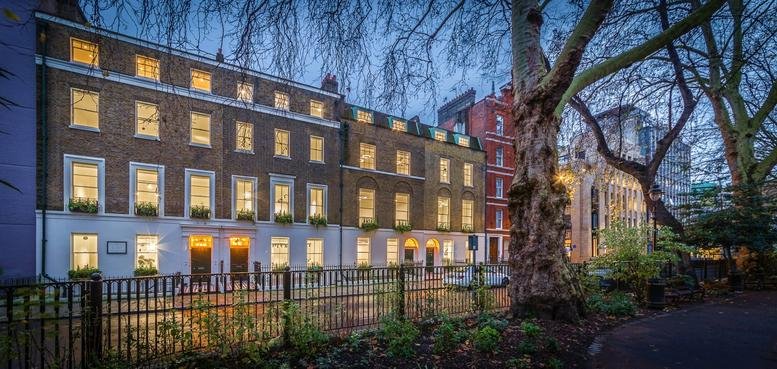 Exterior view of the historic brick facade of 14-17 Red Lion Square at dusk.