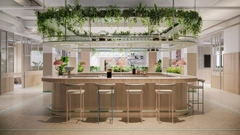 A stylish bar and reception area with a large overhead planter at 14-17 Wells Mews, London.