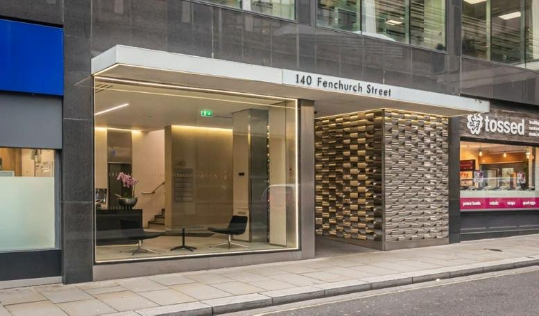 Main street-level entrance with a large glass storefront and clear building signage.