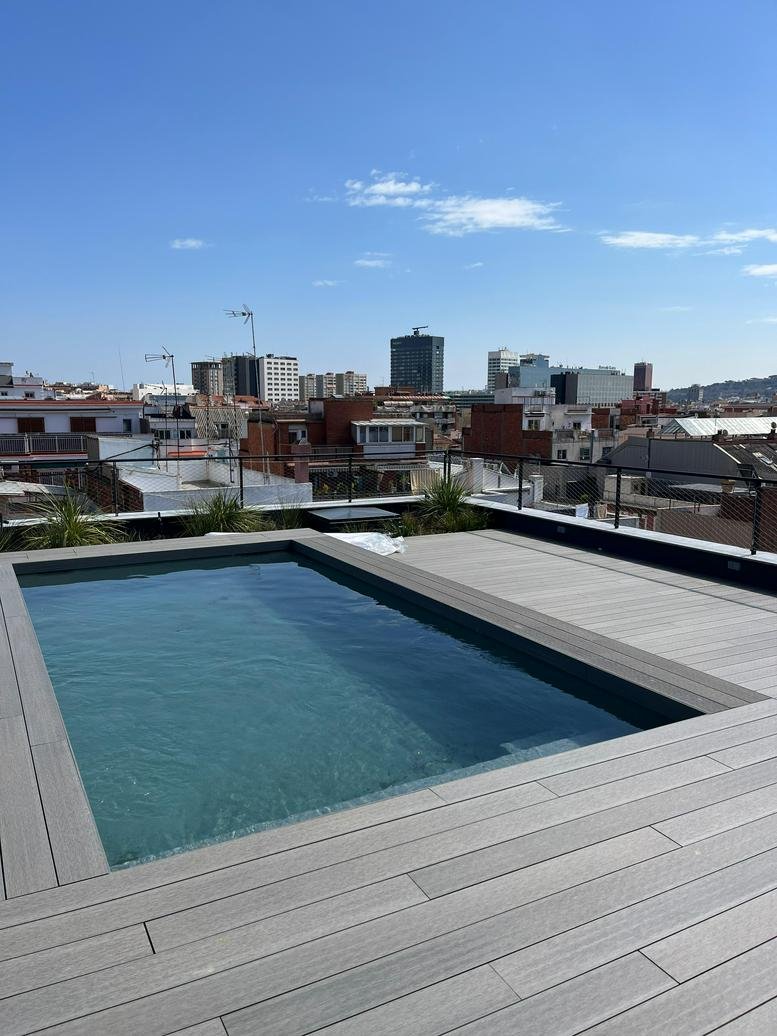 Rooftop terrace featuring a small swimming pool and panoramic city views.