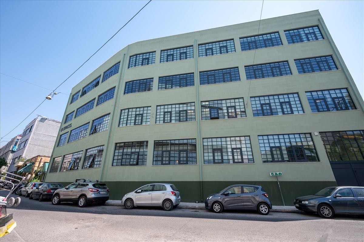 Exterior view of the green industrial-style building at 15, Theanous Str, Athens.