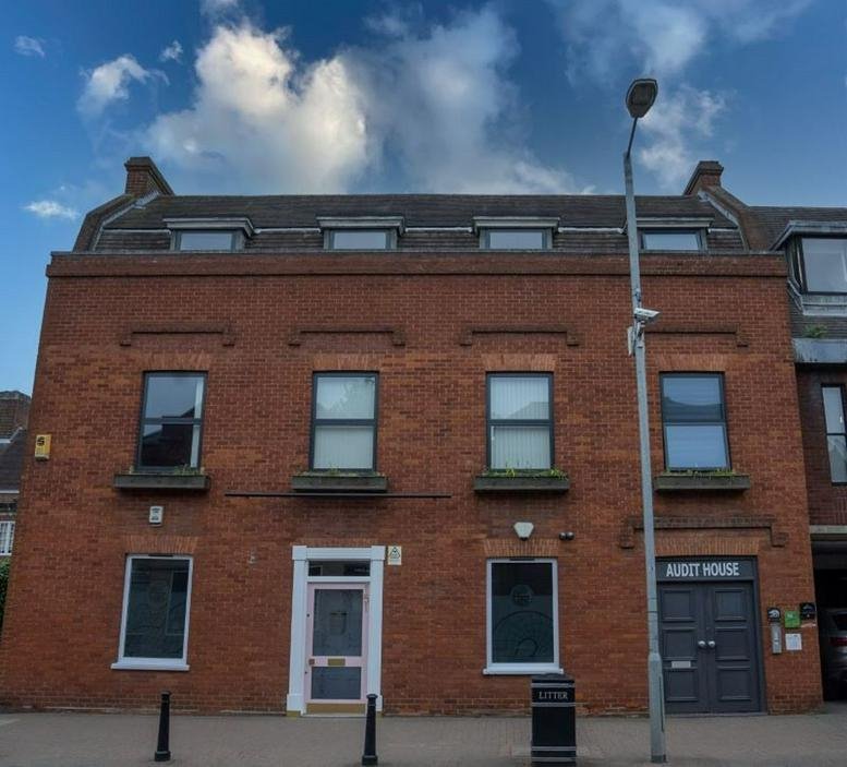 Exterior view of the brick facade at 151 High Street, Billericay, Essex under a blue sky.