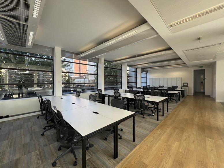 Spacious open-plan workspace at 157-197, Buckingham Palace Road, London with white desks and ergonomic chairs.