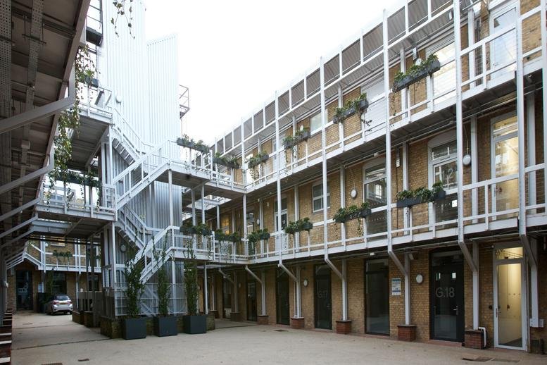The industrial-style courtyard and multi-level walkways at 159-163 Marlborough Road, Islington Studios.