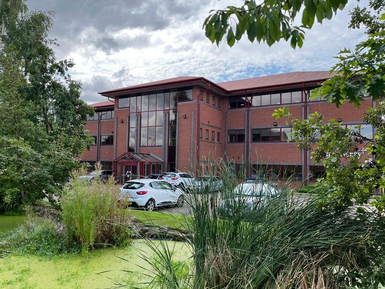 Red brick exterior of the office building at 16 Carolina Way, Quays Reach.