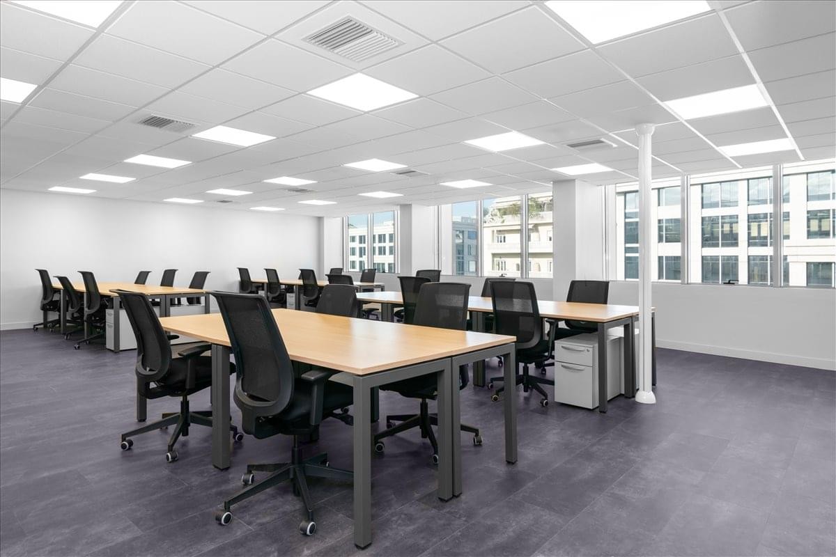 Spacious open-plan workspace at 16 Kifissias av with multiple desks and bright recessed lighting.