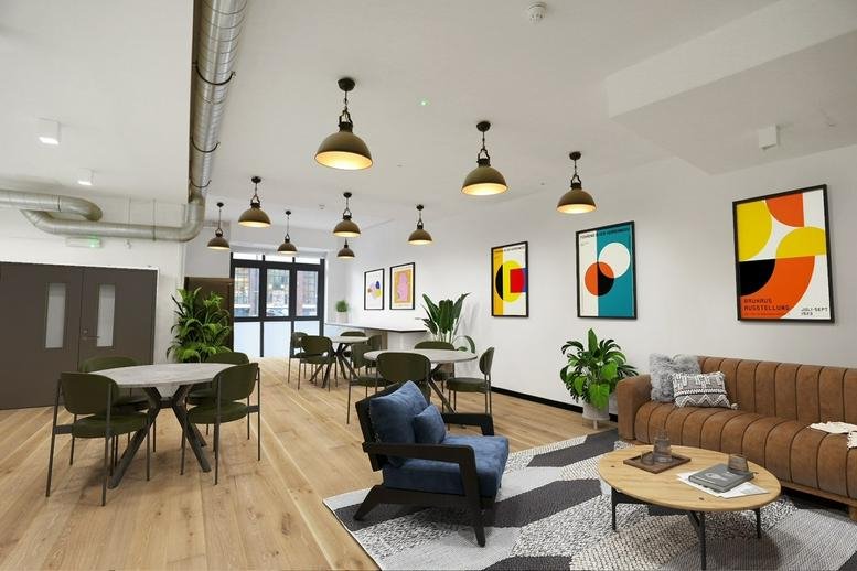 Colorful breakout lounge with a leather sofa, blue armchair, and vibrant geometric wall art.