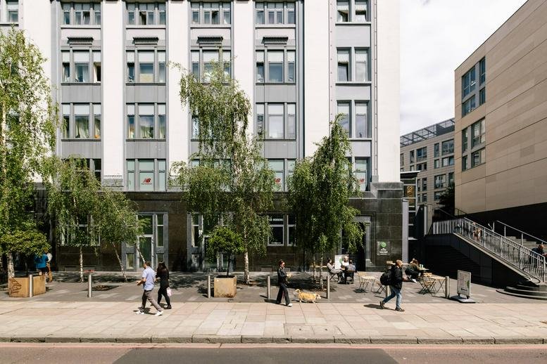 Exterior view of the white facade and street-level entrance of 163 City Rd, London.