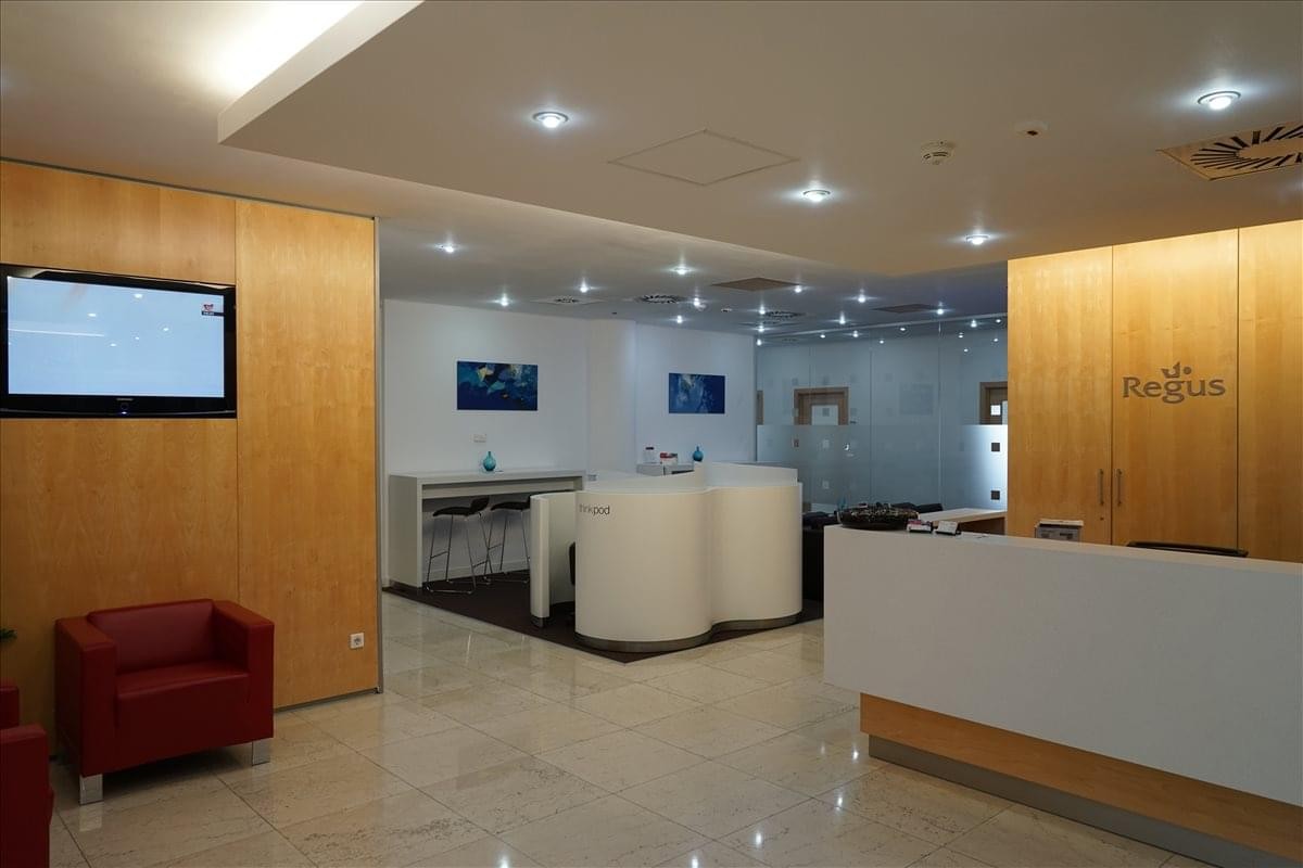 Reception area at 169A, Calea Floreasca, Sector 1, Bucharest with warm wood paneling and a sleek white desk.