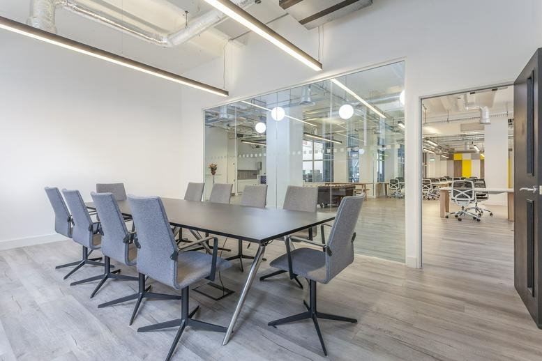 Meeting room at 17 Bevis Marks, London, EC3A with a large grey table and ergonomic chairs.