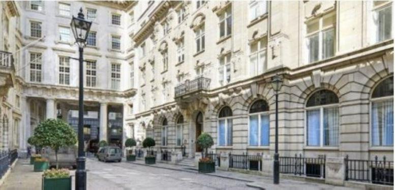 Building exterior featuring a decorative stone entrance and a classic street lamp.