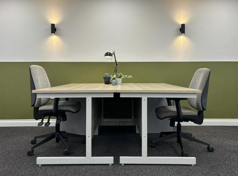 Professional workspace with two desks and a green feature wall at 17, White Horse Yard, Towcester.