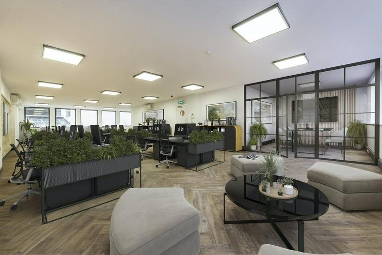 Spacious open-plan workspace at 177 Tottenham Court Road with lounge seating and glass-partitioned meeting room.