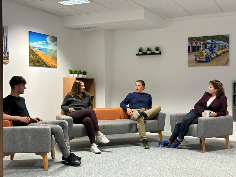 Spacious communal lounge at 18 Christchurch Road, Telephone House, with grey seating and wall art.
